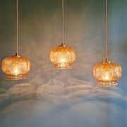 Vintage trio of amber glass pendants, 1960s-70s.