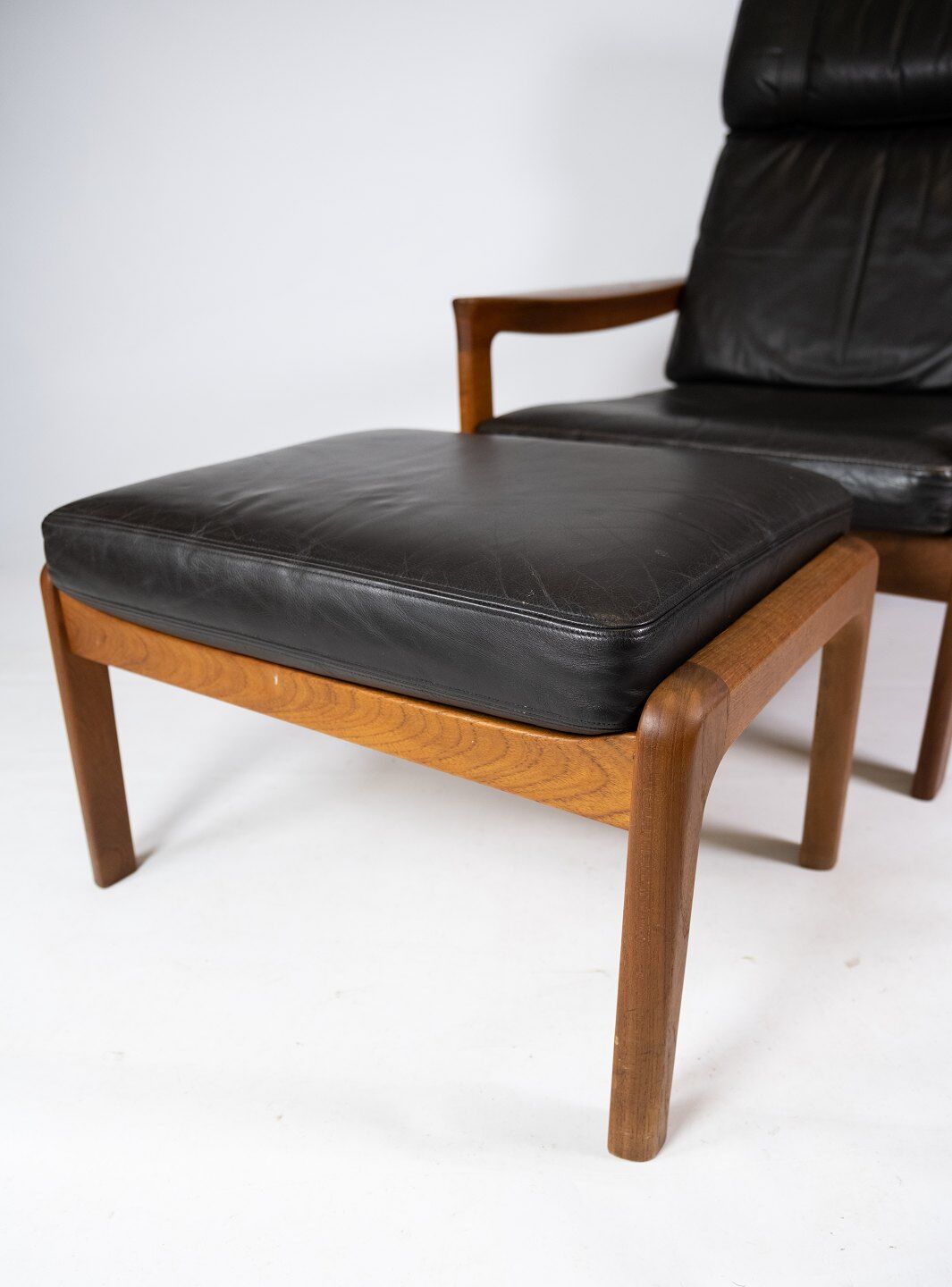 Easy chair with stool in teak upholstered with black leather design Arne Wahl Iversen