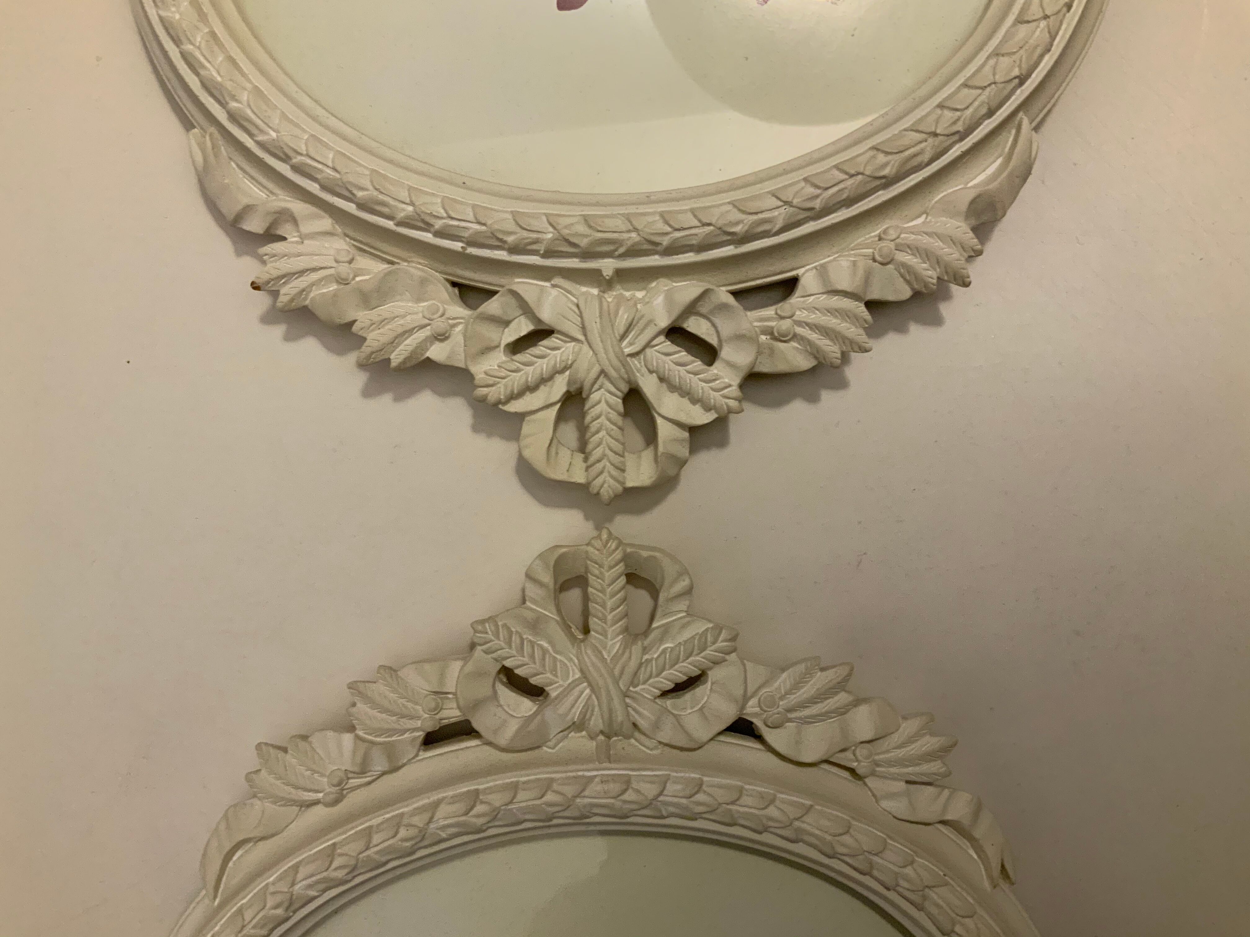 2 off-white oval plaster frames