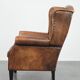 Large and comfortable sheepskin leather wingback chair with black piping