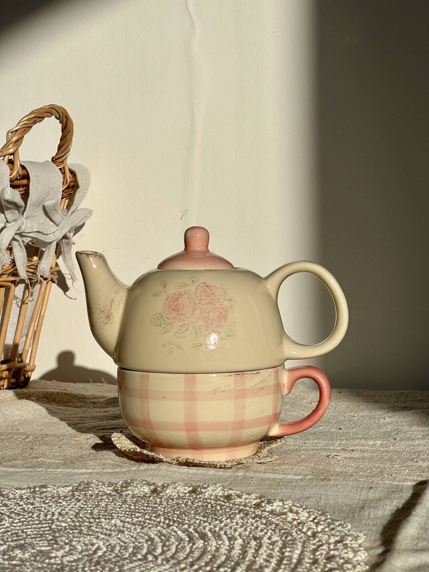 Vintage porcelain teapot and cup set with pink and beige floral and gingham pattern