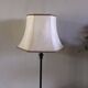 Table lamp with a patinated base and vintage woven shade.