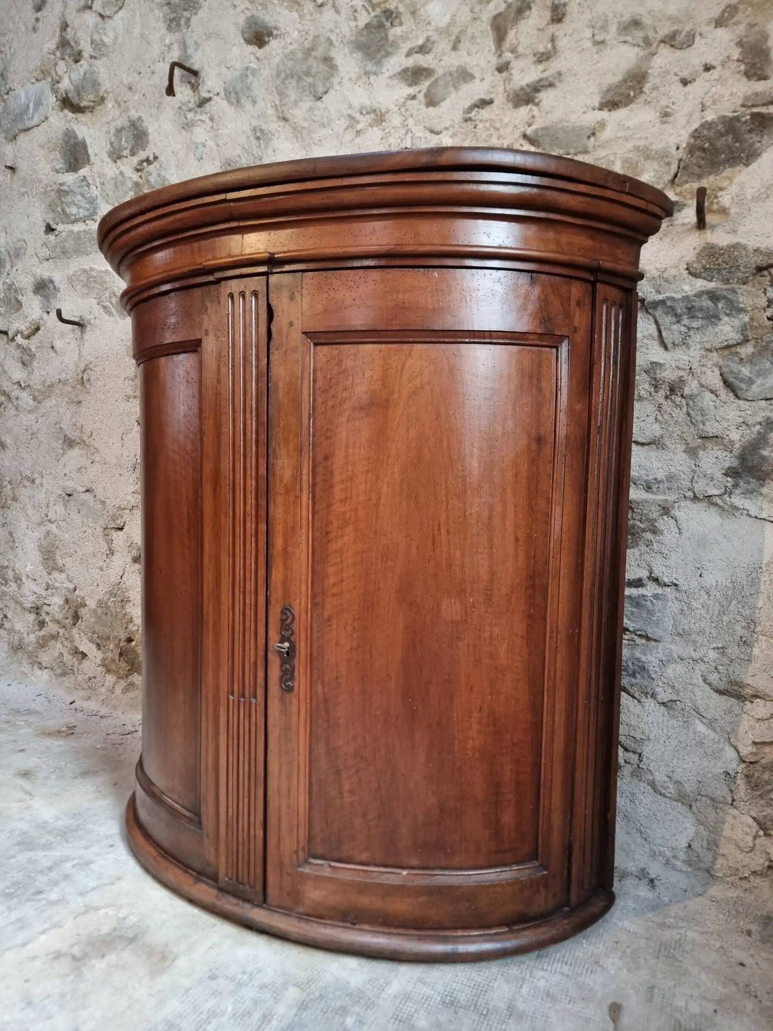 Antique demi-lune cabinet in walnut, late 18th century, French château.