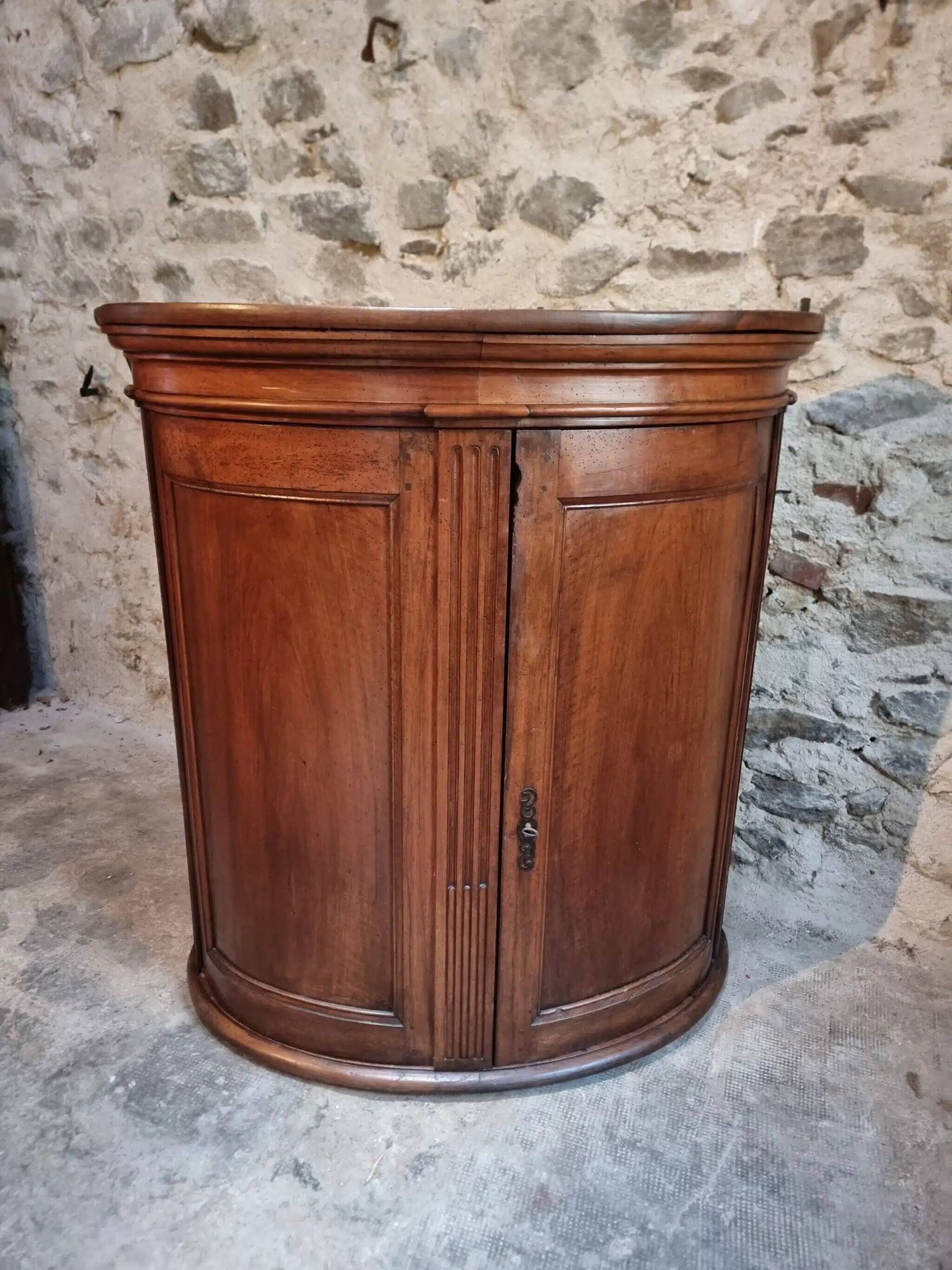 Antique demi-lune cabinet in walnut, late 18th century, French château.