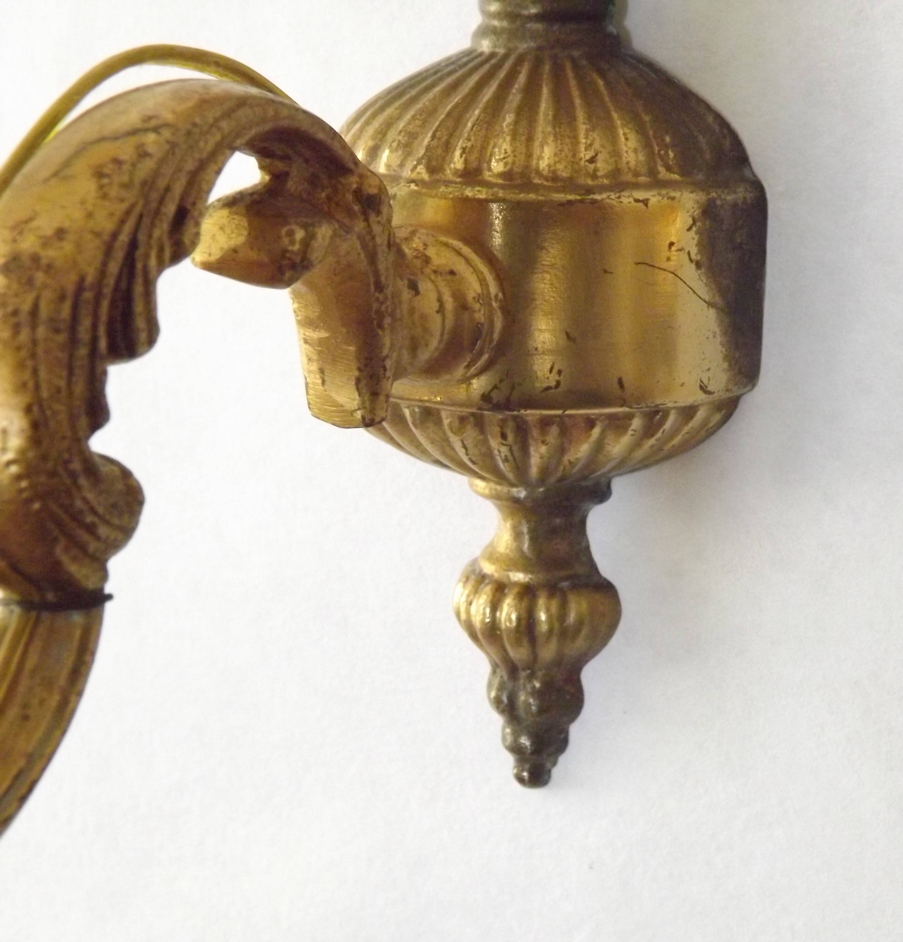 Pair of simple vintage French wall sconces in Art Nouveau bronze with leaf-shaped details.