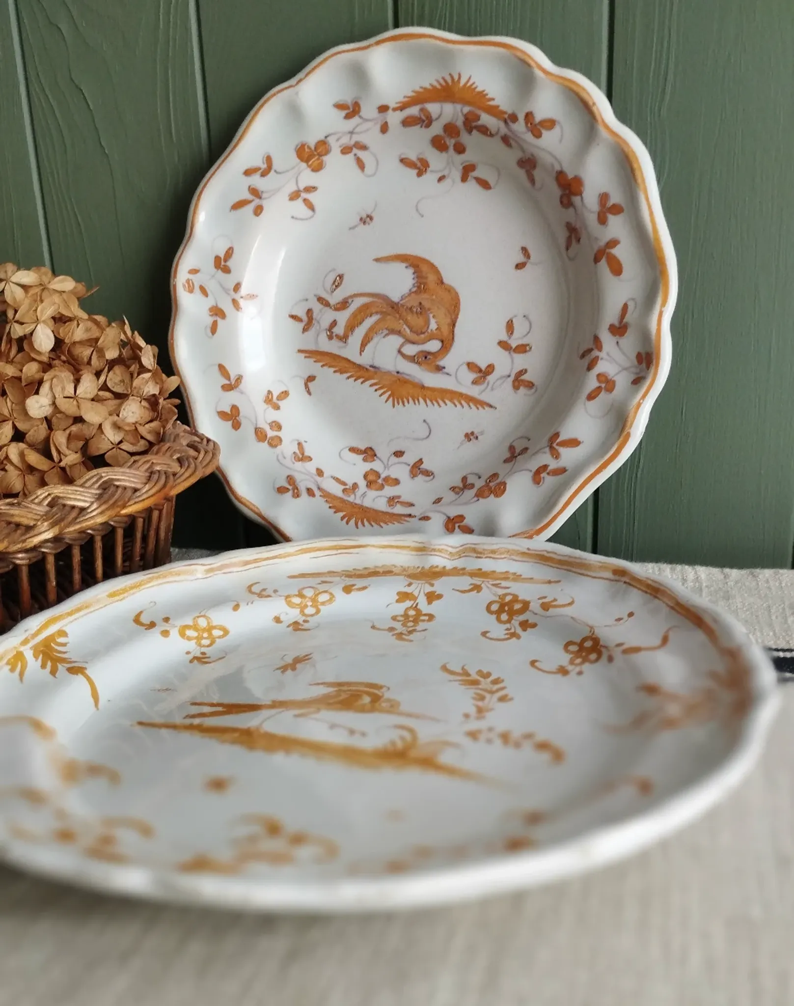 Pair of antique plates with a bird of paradise design in the style of Moustiers.