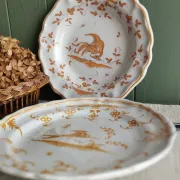 Pair of antique plates with a bird of paradise design in the style of Moustiers.