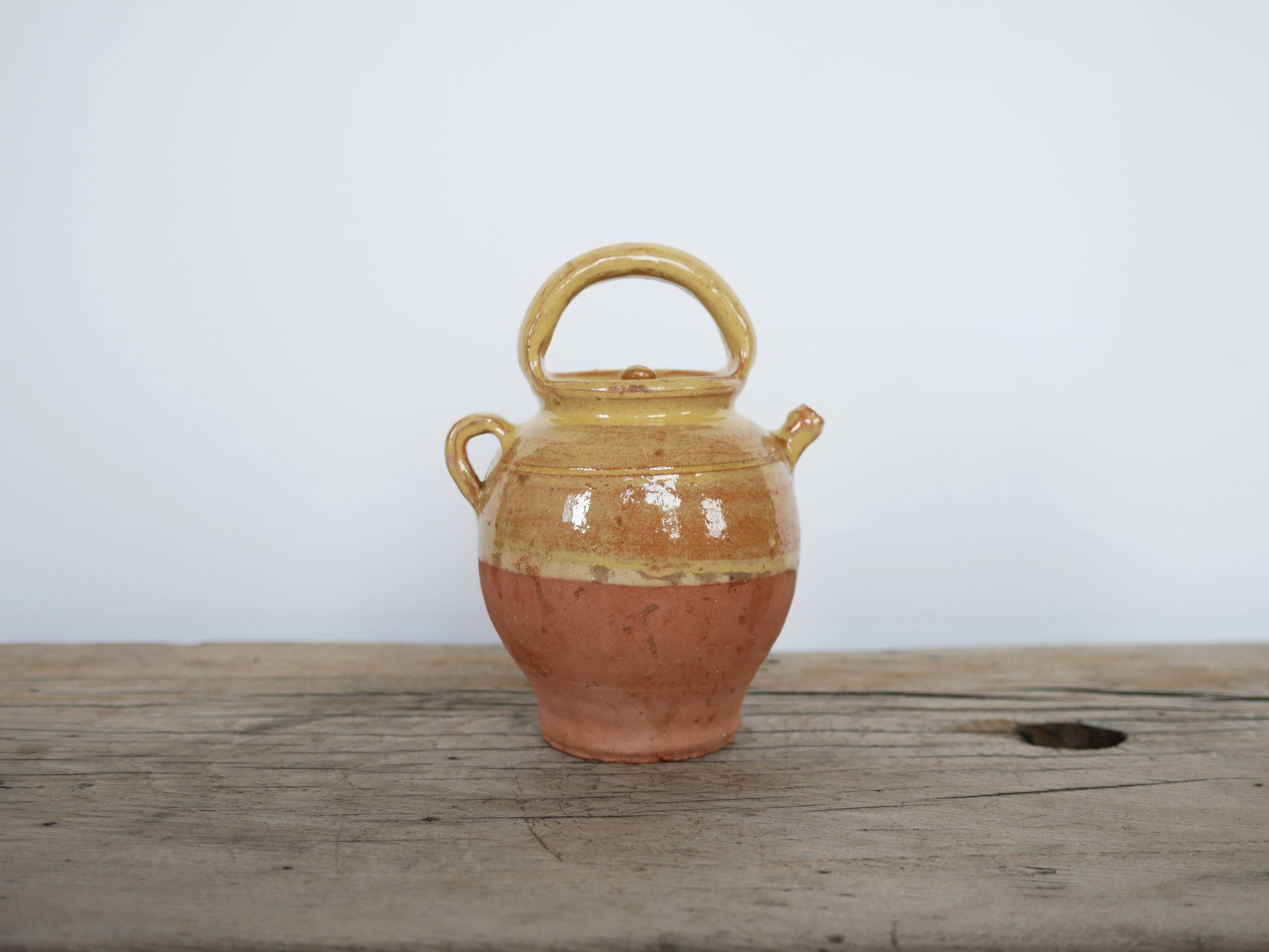 Old gargoulette pot in glazed terracotta