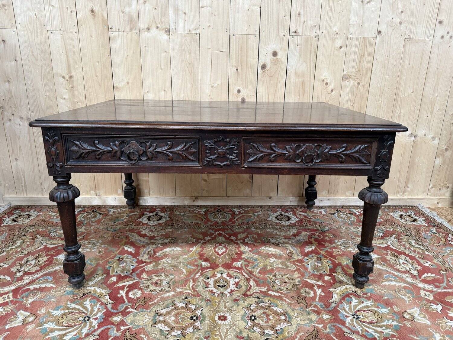 Middle table in a sculpted Louis XIII style living room.