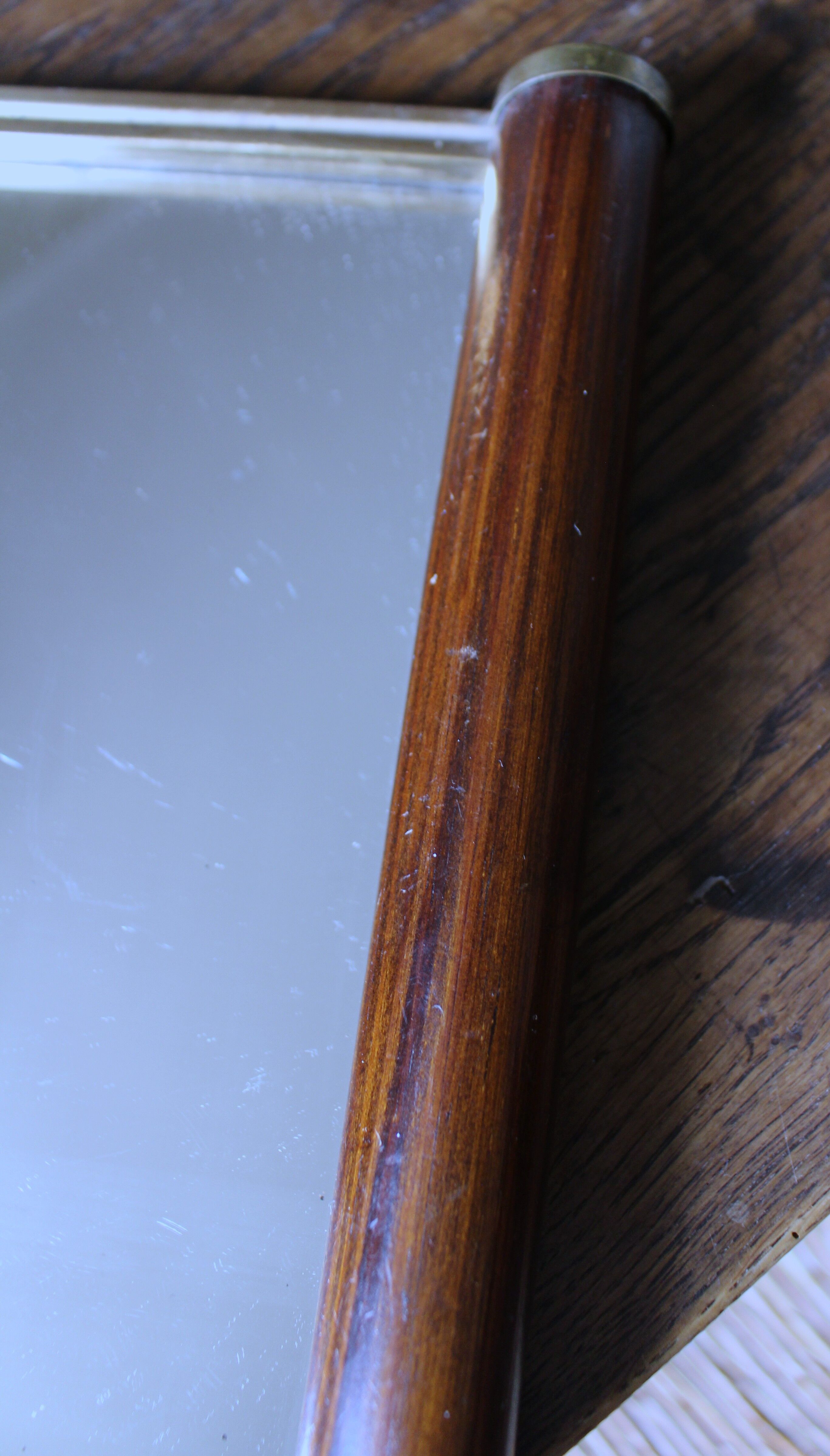 Rectangular mirror tray with wooden handles and gilding.