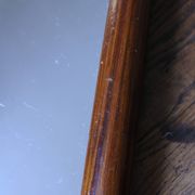 Rectangular mirror tray with wooden handles and gilding.