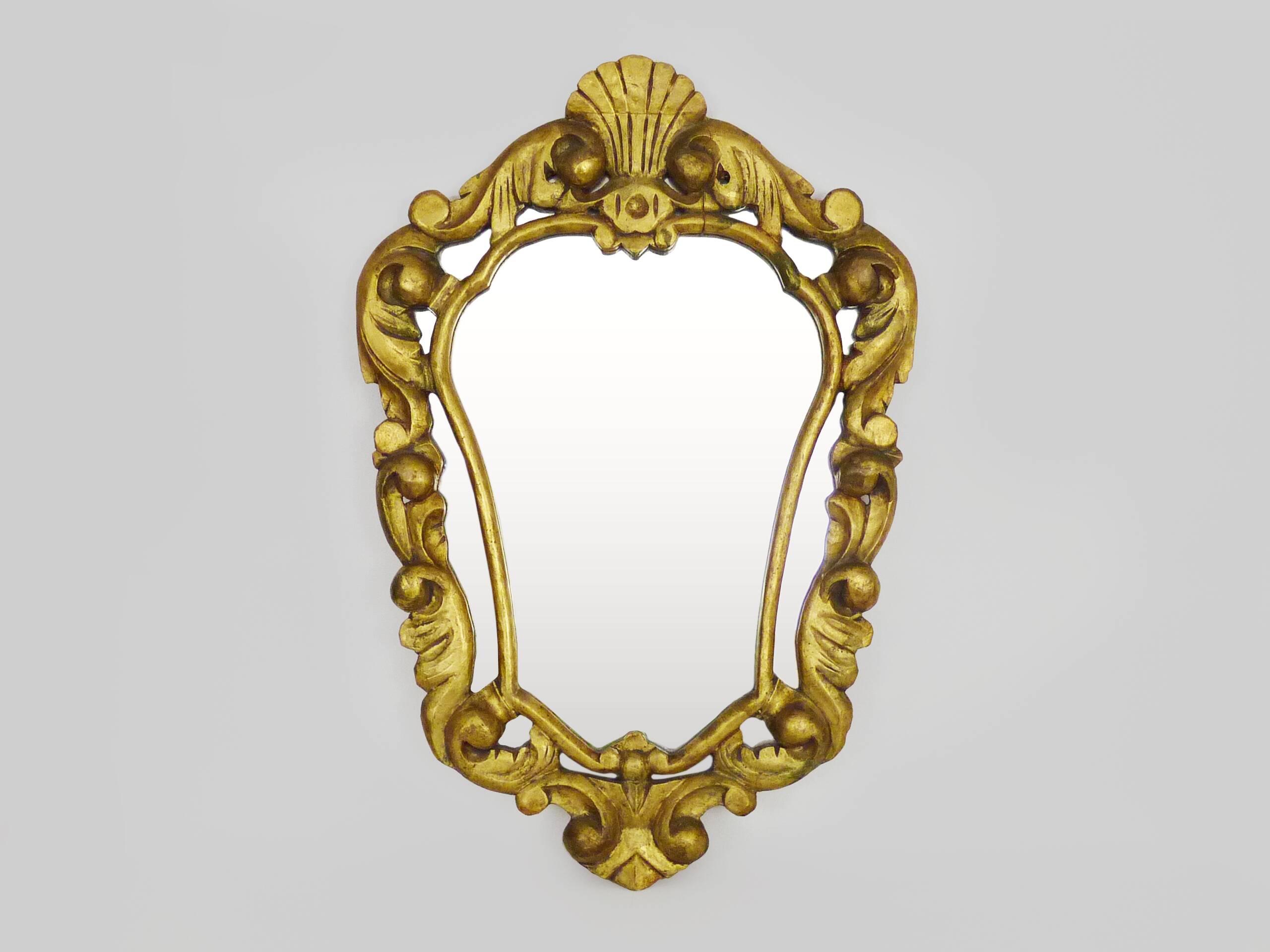 Old wall mirror in wood and gilded stucco with shell decoration, Louis XV style pediment mirror