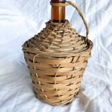Circled with wicker demijohn