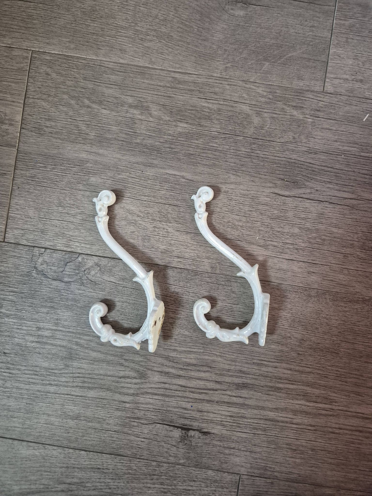 set of 2 vintage white cast iron hooks, small paint chips from the year