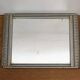 Art Deco mirror in silvered wood, stylised geometric frieze.