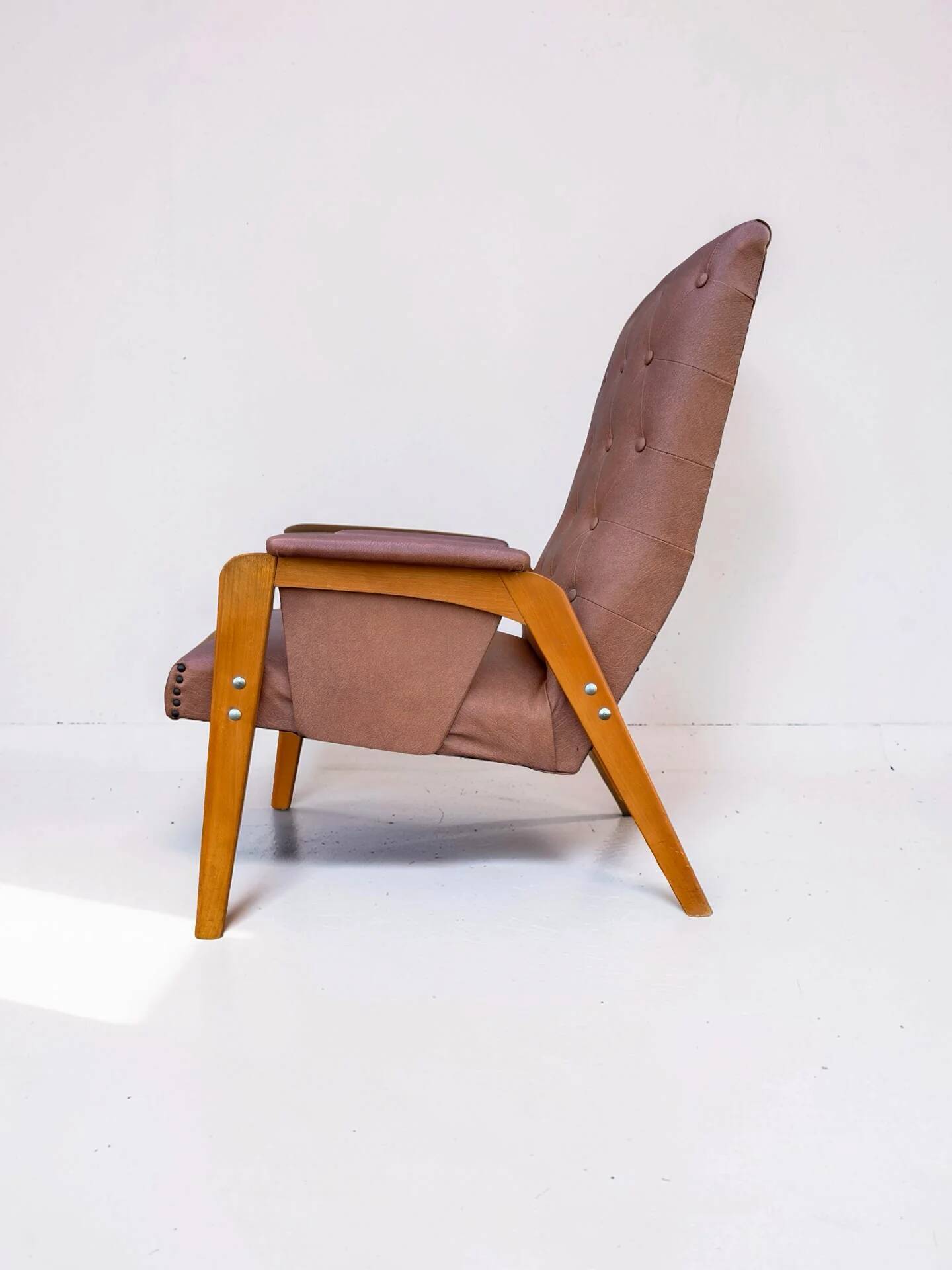 Vintage armchair in light brown faux leather, 1960s.