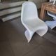 10 white chairs in the style of Verner Panton