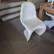10 white chairs in the style of Verner Panton
