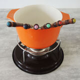 Nomar fondue service in orange cast iron