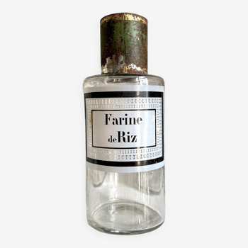 Rice flour apothecary bottle in transparent glass and green metal