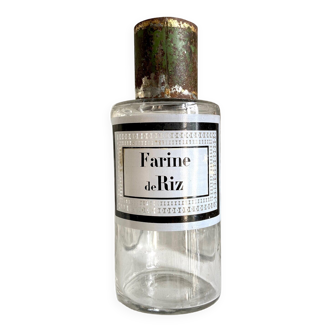 Rice flour apothecary bottle in transparent glass and green metal