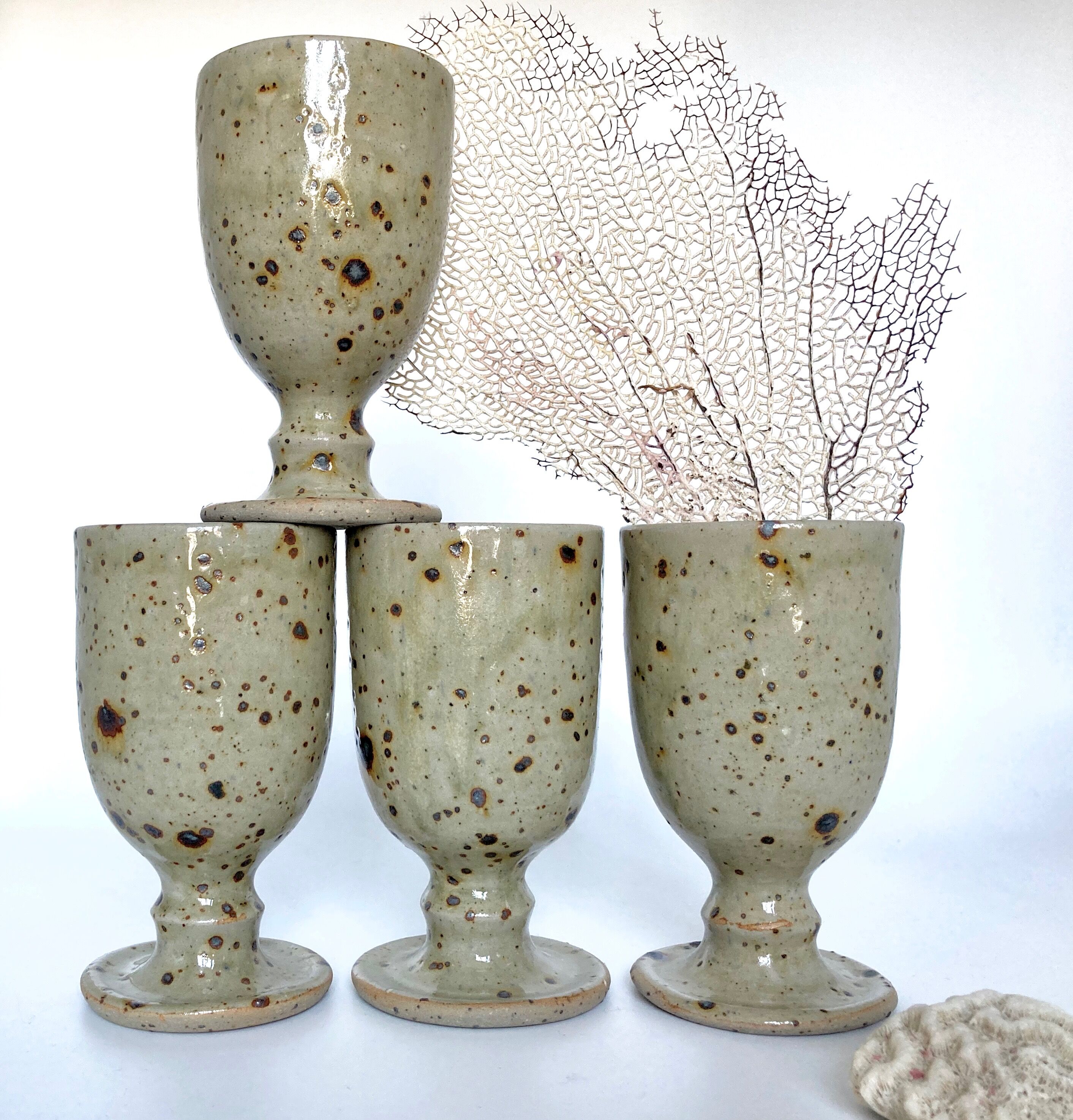 Four cups made of pyrity sandstone