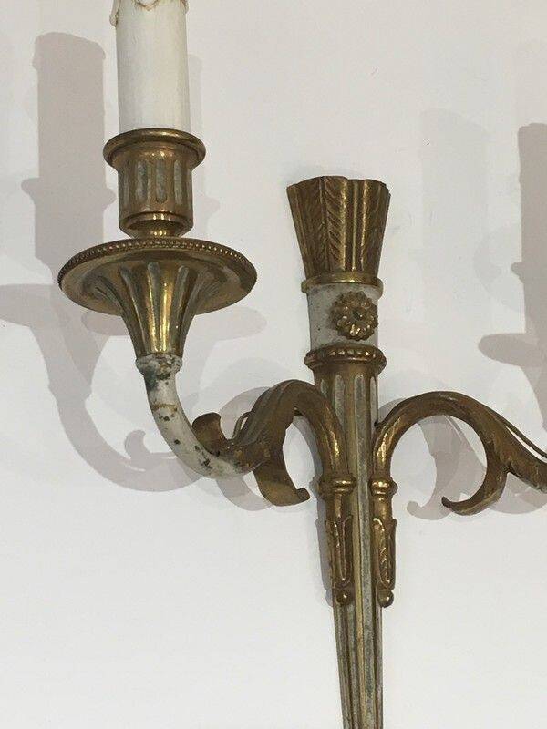 Pair of Louis XVI style wall sconces in bronze with an off-white patina
