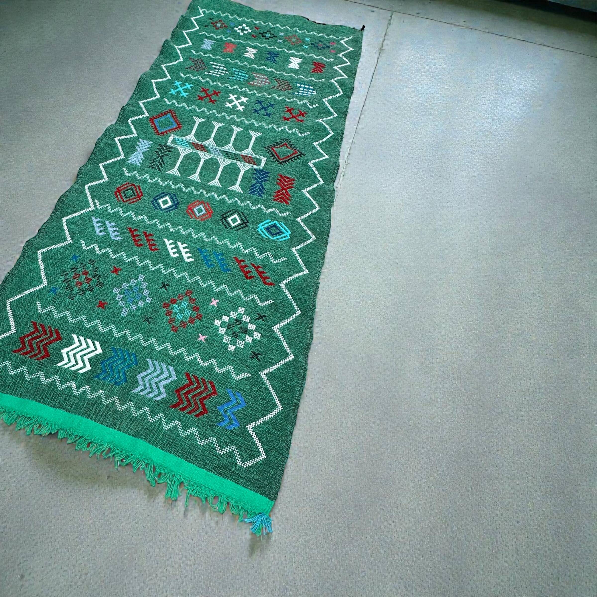 Handwoven green Moroccan hallway rug with geometric patterns.