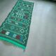 Handwoven green Moroccan hallway rug with geometric patterns.