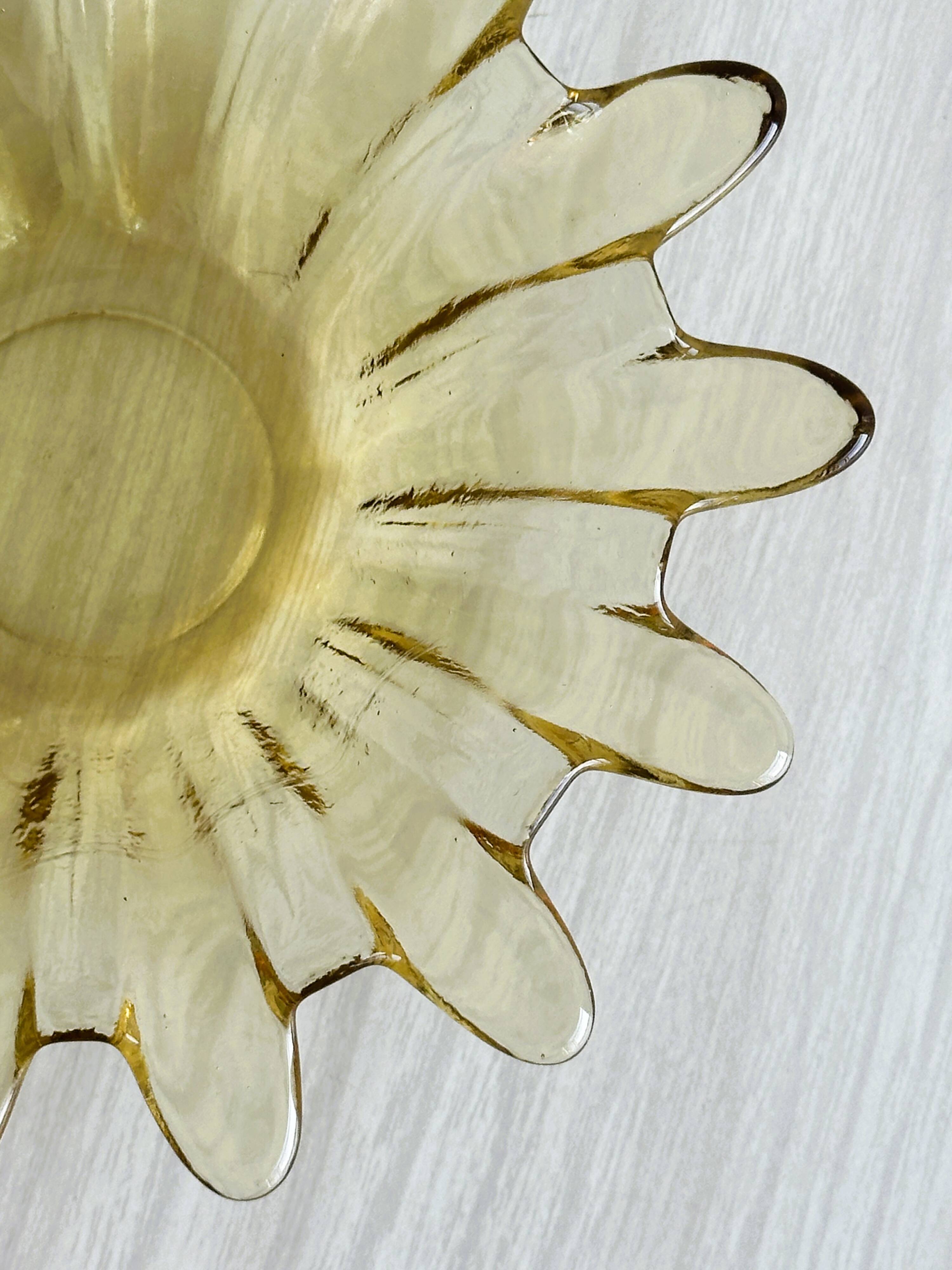 Empty pocket in yellow translucent blown glass, ashtray.