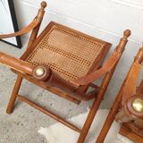 Pair of folding chairs in bamboo and caning, leather and brass