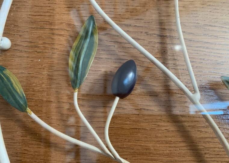 Round wrought iron and glass tray decorated with olives and foliage