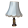 Vintage brown and gold desk lamp made of carved wood and brass, with a fringed shade.