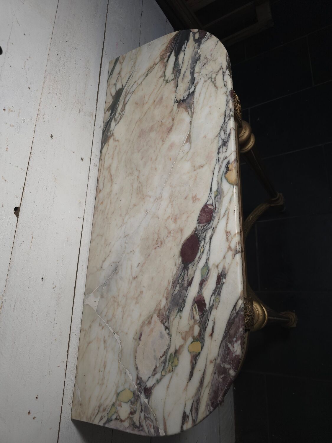 Louis XVI style console in gilded wood with a marble top.