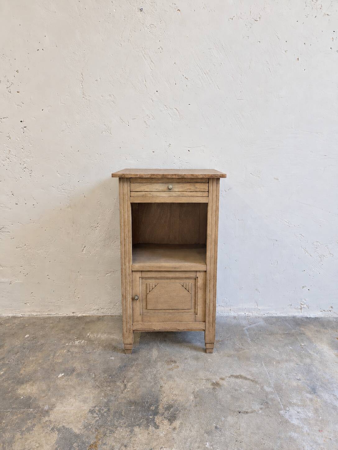 Antique wooden bedside table with a pink/orange marble top.