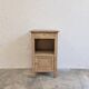 Antique wooden bedside table with a pink/orange marble top.