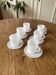Espresso coffee cup service, Nestlé promotional items, in white glass.