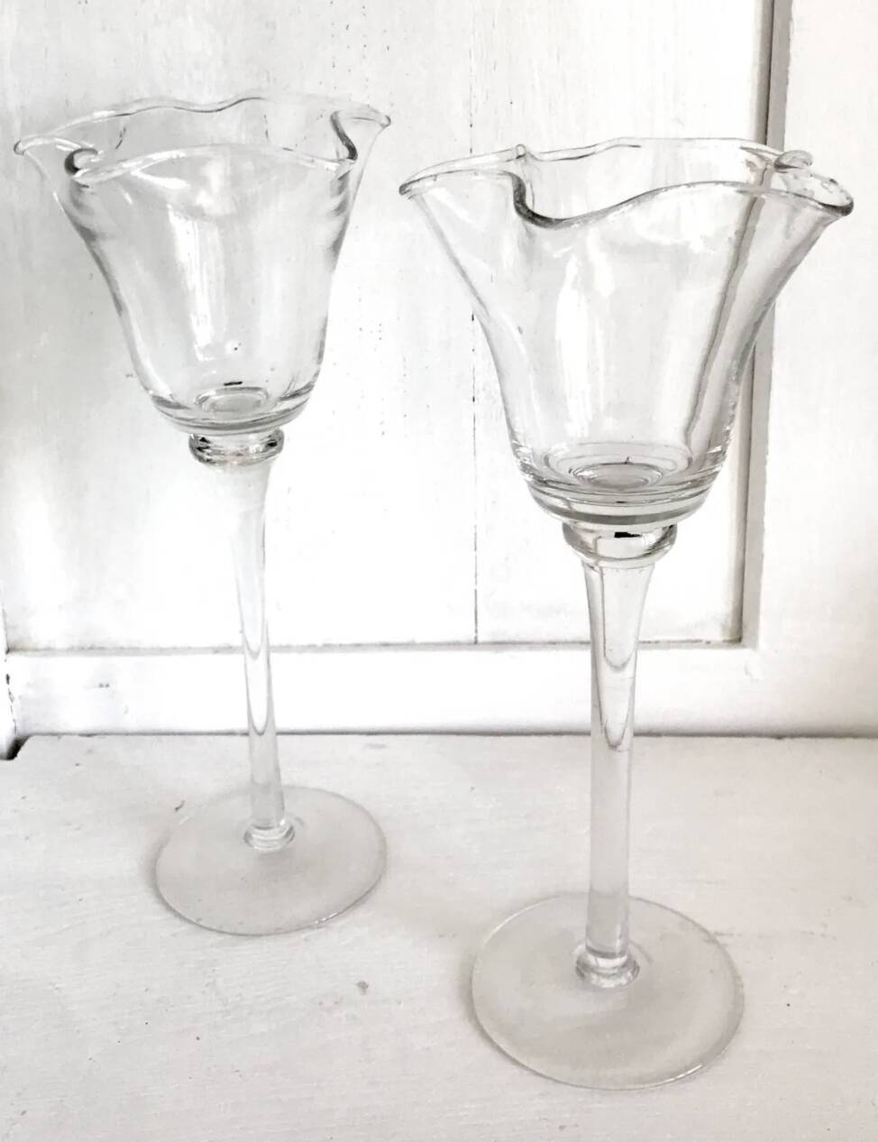 Pair of glass candlesticks on a stand