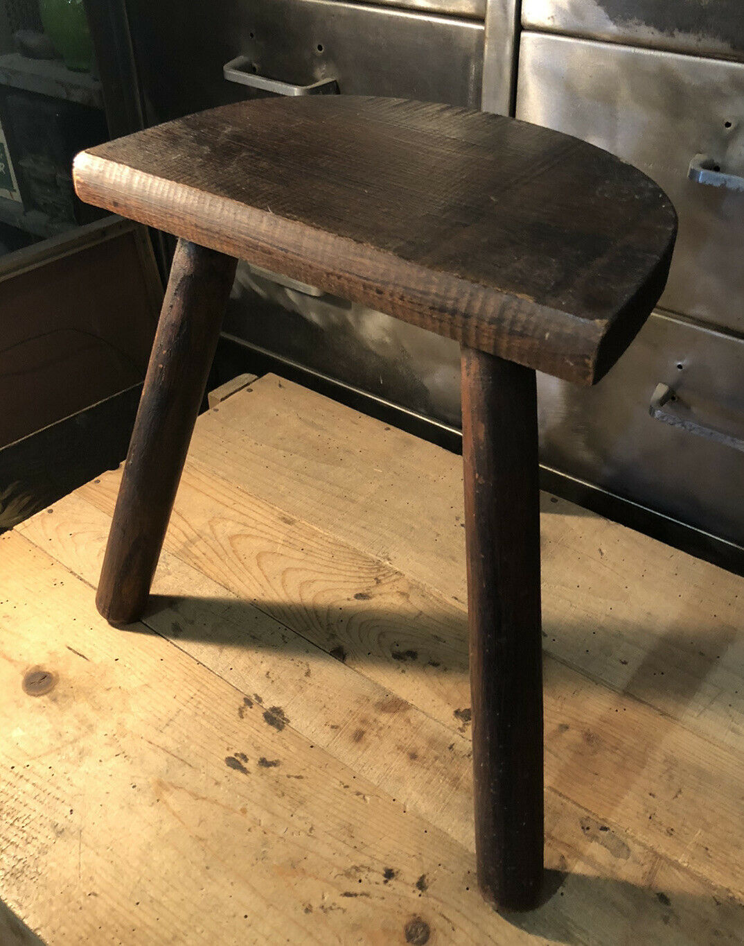 Wooden milking stool on tripod base