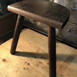 Wooden milking stool on tripod base