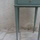 Bedside table, coffee table enhanced in smoky green, wooden top.