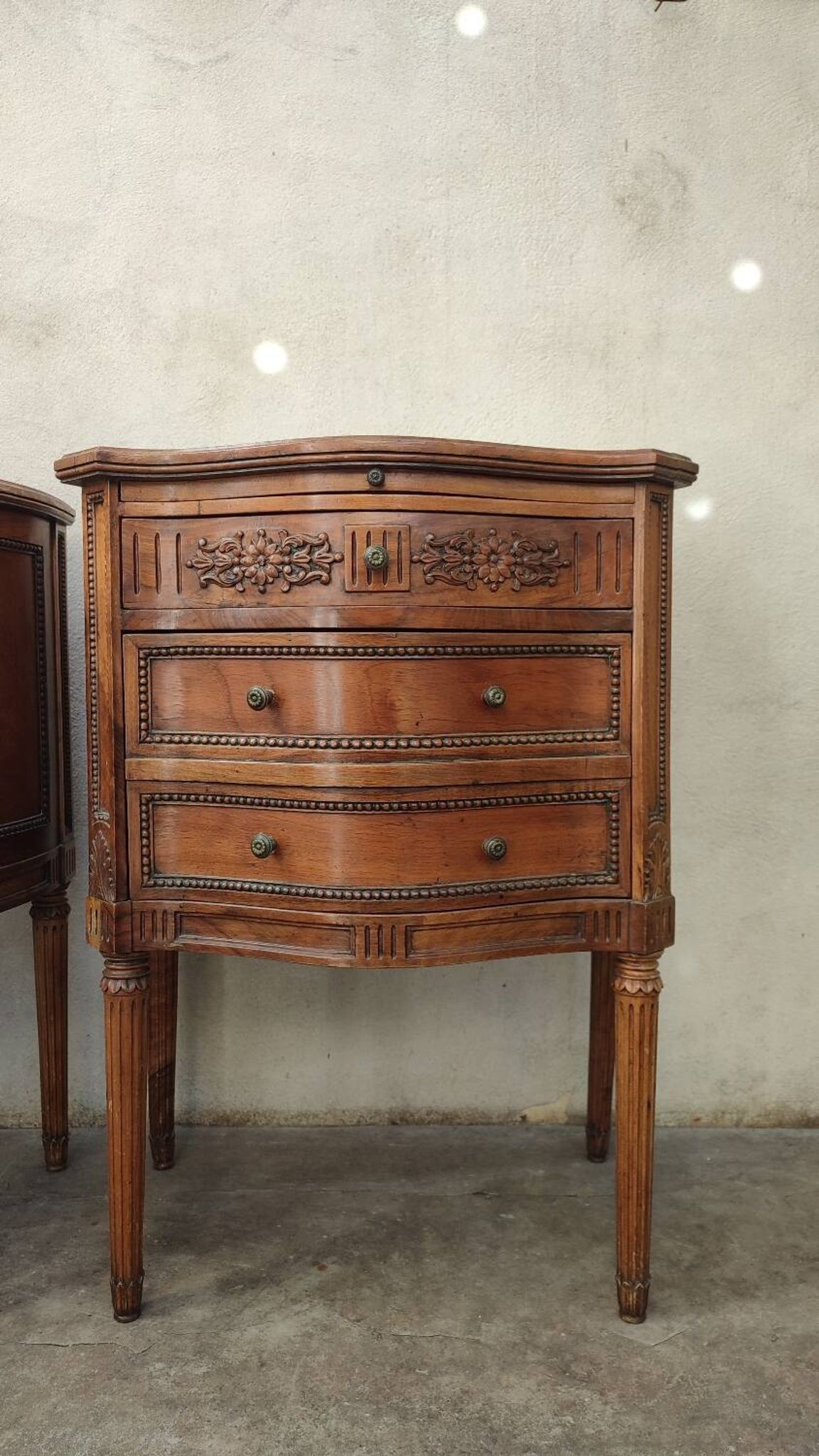Pair of bow-fronted chests of drawers in walnut
