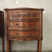 Pair of bow-fronted chests of drawers in walnut