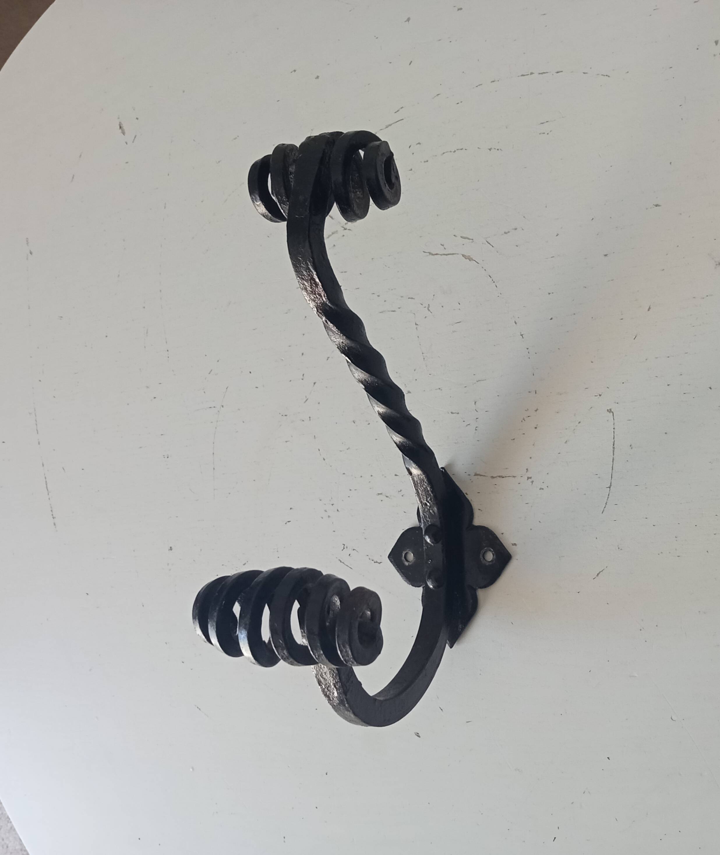 Brutalist wall coat rack in wrought iron.