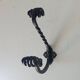Brutalist wall coat rack in wrought iron.