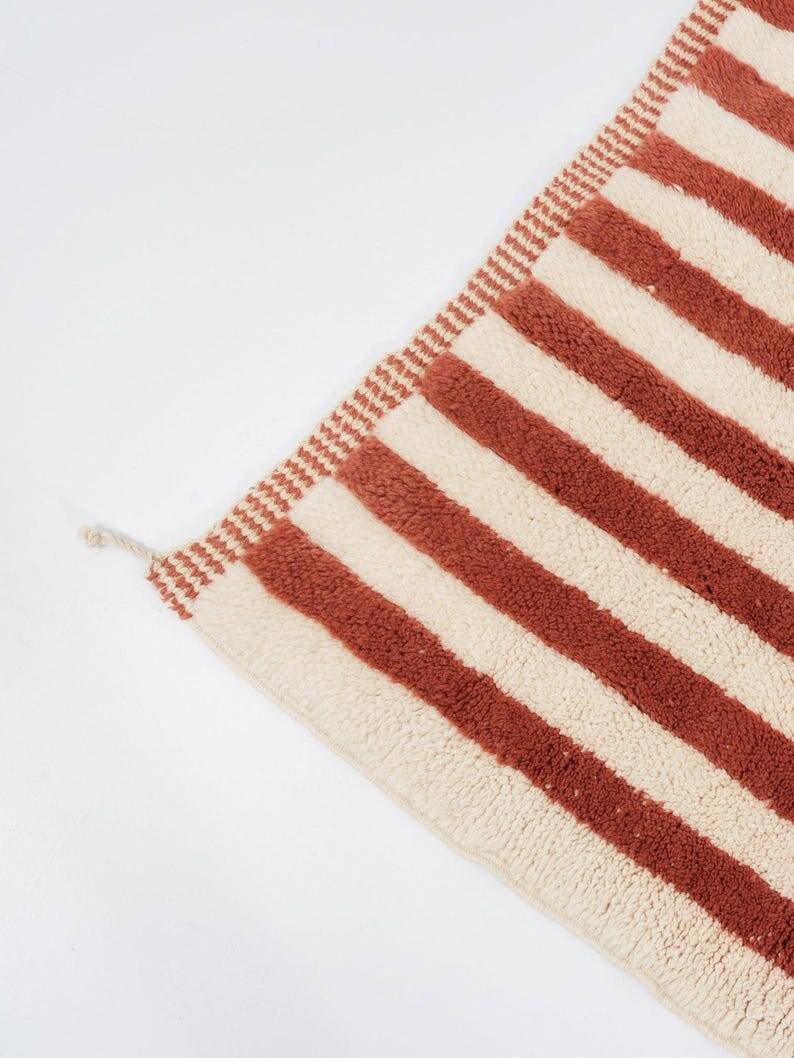 A handmade Moroccan striped terracotta rug, 150/250cm