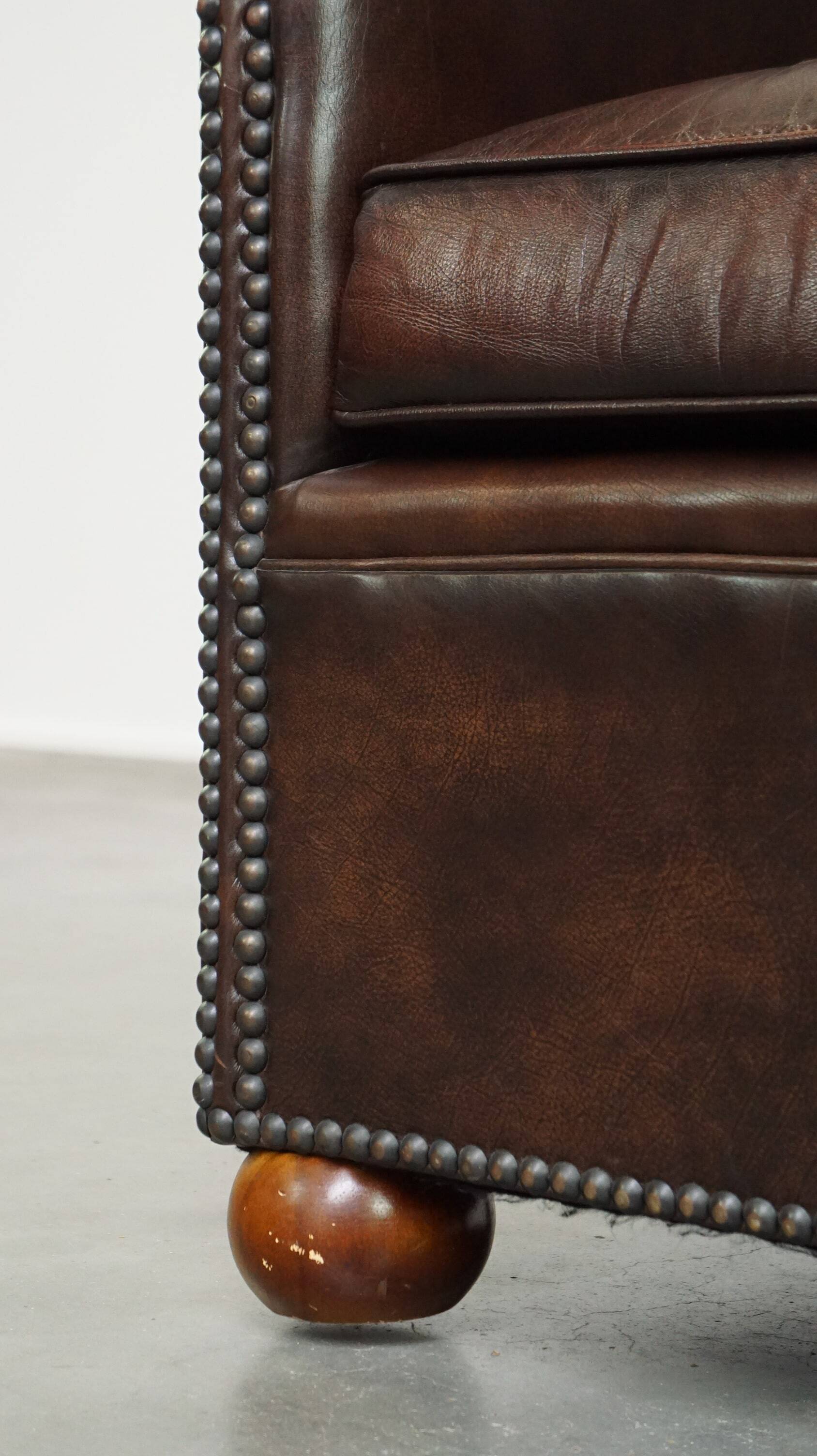 luxury dark leather club chair with English-style ball feet