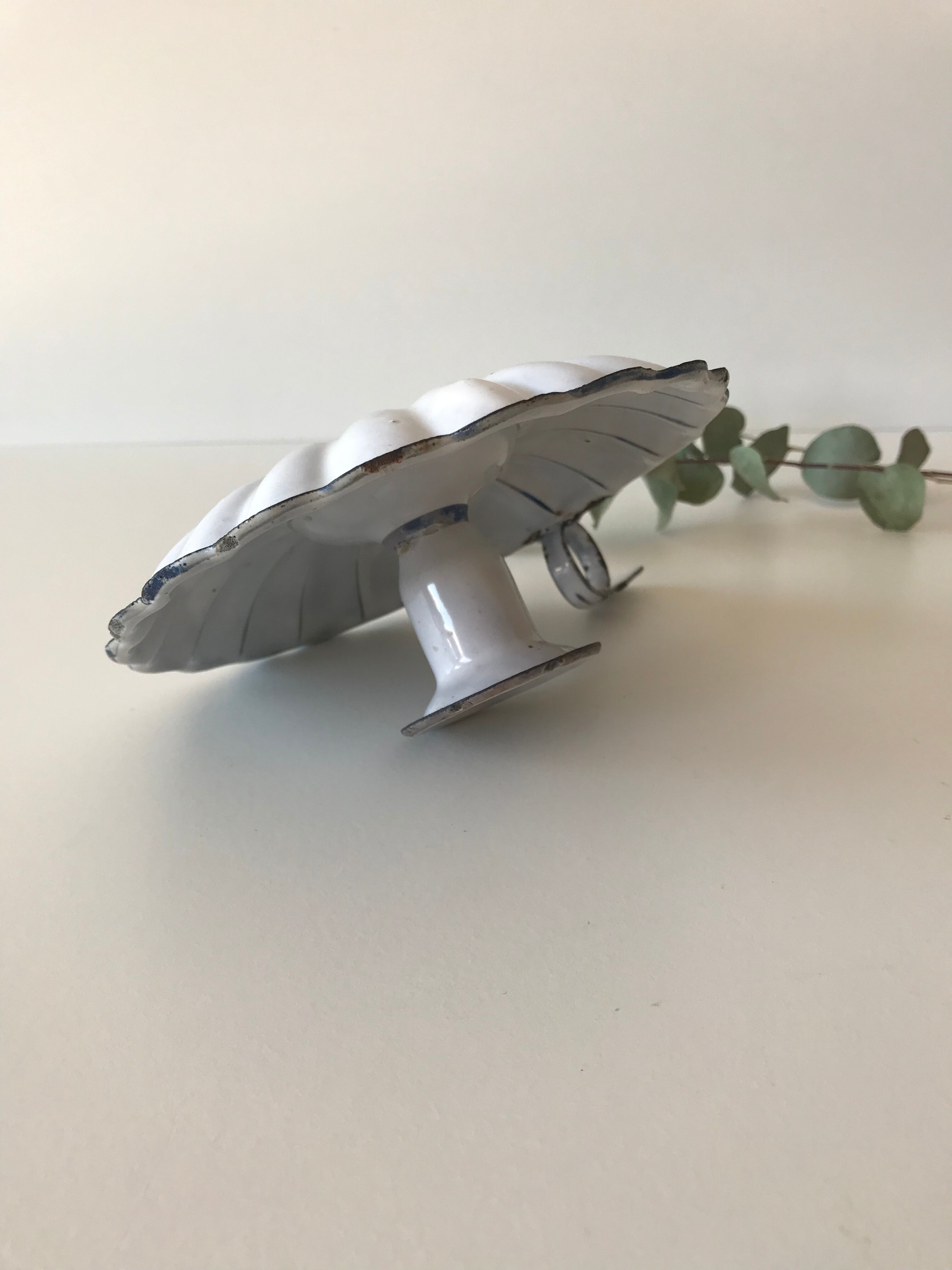 Candlestick in white enameled metal