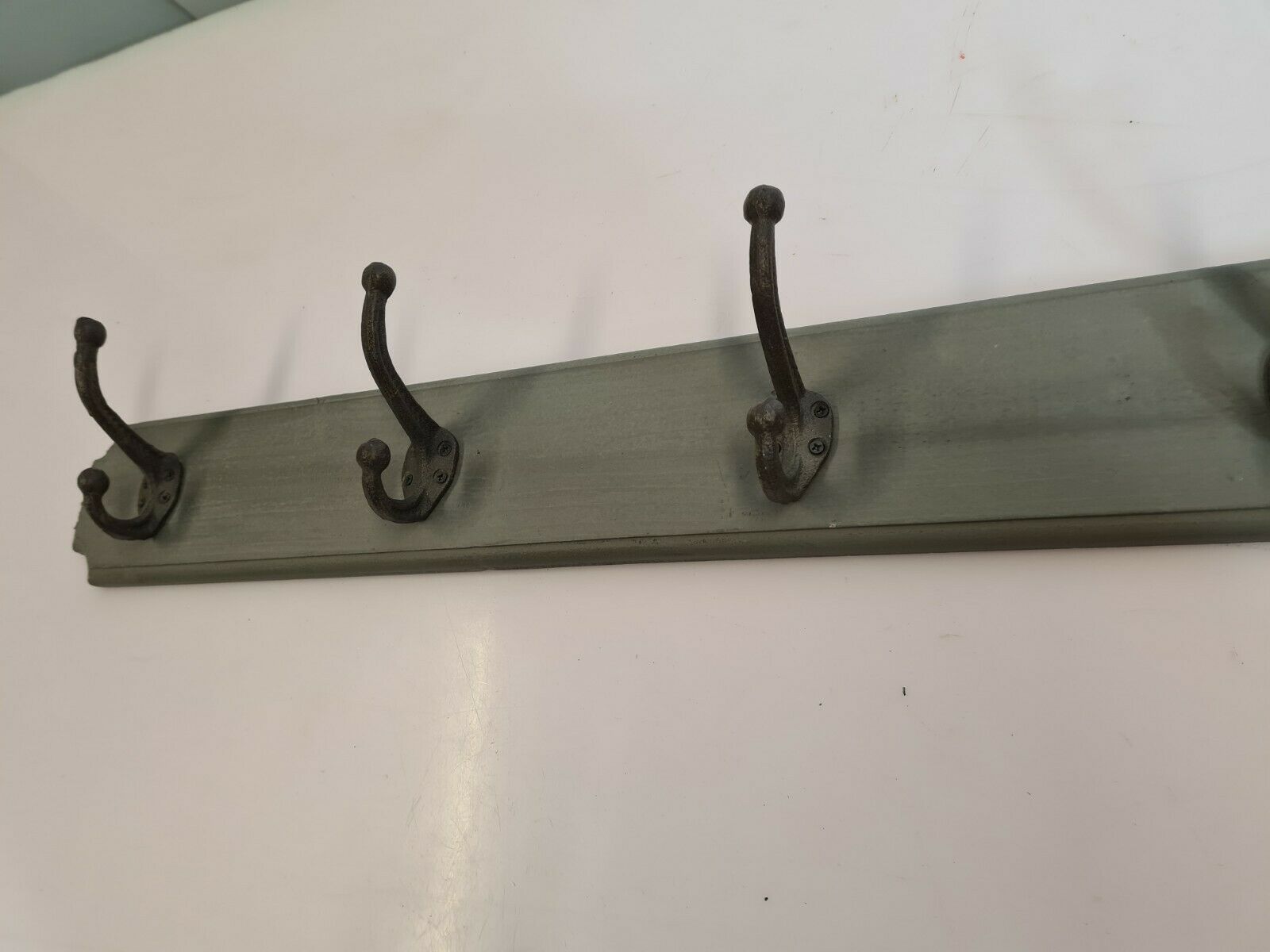 Wooden coat rack with cast iron hooks