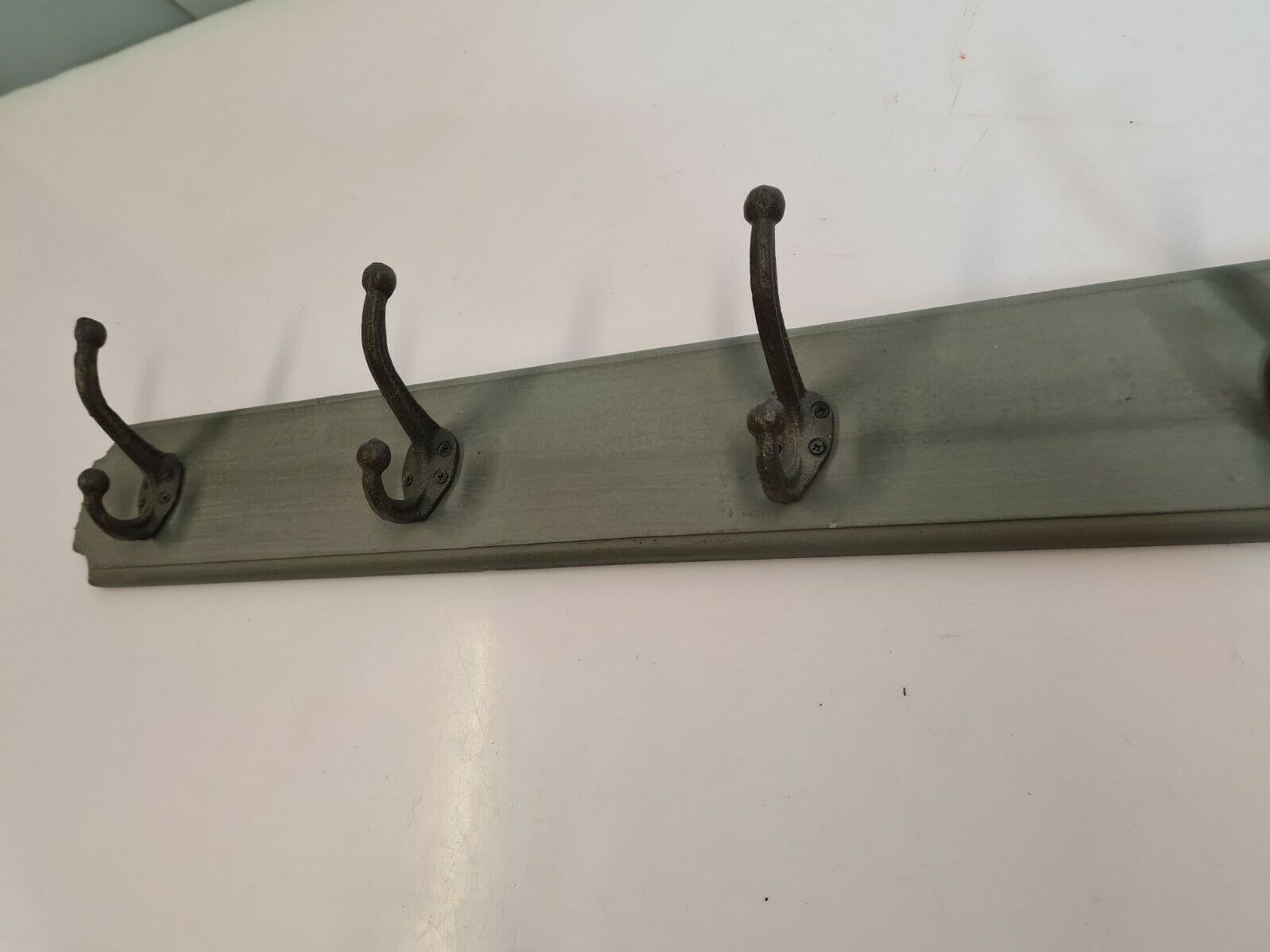 Wooden coat rack with cast iron hooks